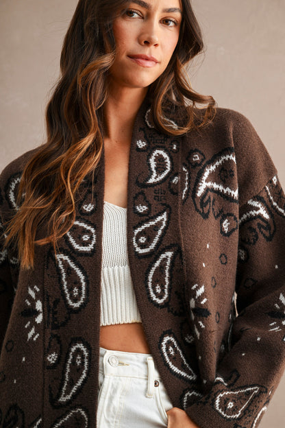 Women’s paisley jacquard knit cardigan with open front, shawl collar and relaxed fit.